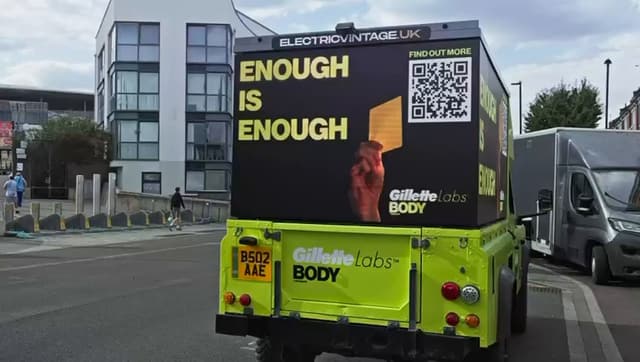 Rear view of our Gillette Labs AdRover on the road, the ELECTRICVINTAGE.UK banner above a screen reading Enough is enough