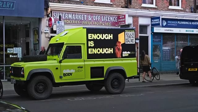 Our Gillette Labs AdRover parked on a high street, its side screen reading Enough is enough