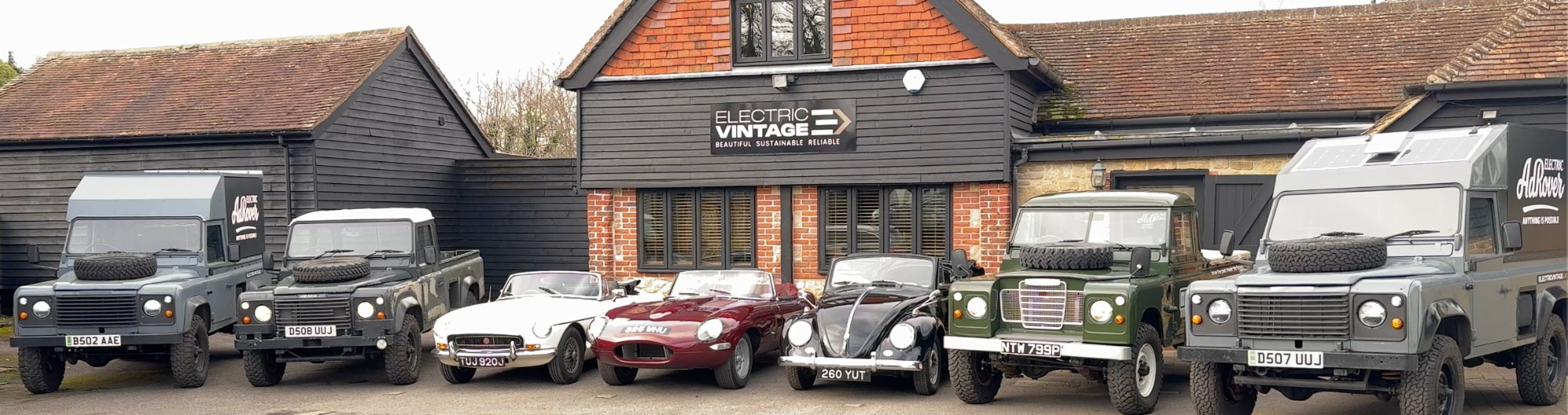 The Electric Vintage fleet — all seven vehicles at Eashing Farm HQ